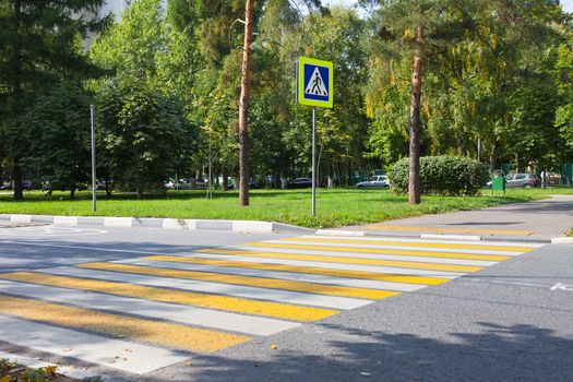 Crossroad with yellow and white stripes in city