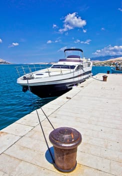 Yacht on mooring bollard dock vertical view