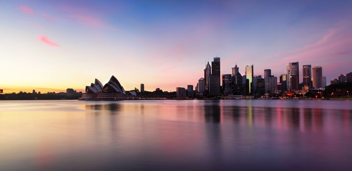 Sydney city skyline of office buildings and skyscrapers and Opera House along Sydney Harbour in the morning at sunrise