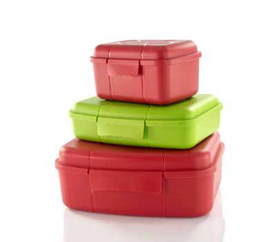 stack of red and green lunchboxes isolted on white