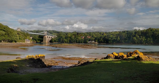 The Menai suspension bridge was built by Thomas Telford and opened in 1826. It connects Anglesey to the Welsh mainland.