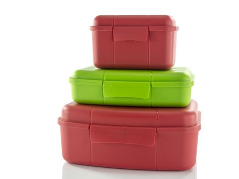 stack of red and green lunchboxes isolted on white