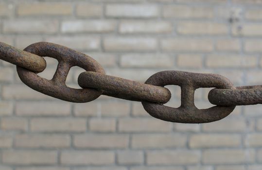 old rusted chain connections on blurry background