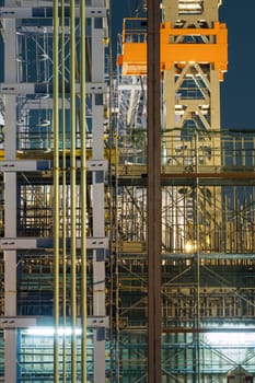 detailed high-rise construction site well illuminated by night