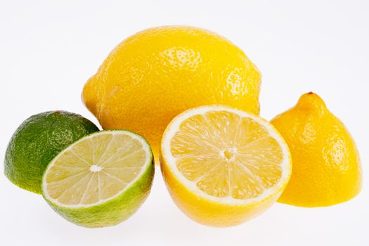 the cut yellow lemons and green  limes isolated on white background