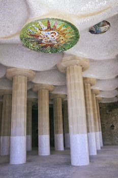 huge columns and mosaic ceiling in famous  Sala Hipostila in Park Guell, Barcelona which were designed by modernism architect Antoni Gaudi