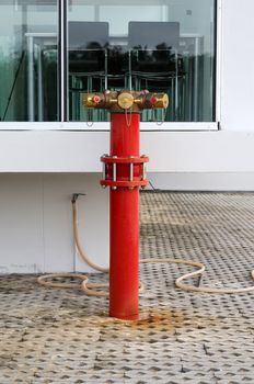 Red metallic fire hydrant or Fire Department Connection on street 