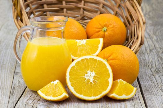 orange juice and fresh fruits on wooden background