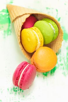 Colorful Macarons in ice cream cone. Macro, selective focus