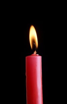 red candle in front of black background