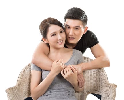 Attractive young Asian couple, closeup portrait on white.