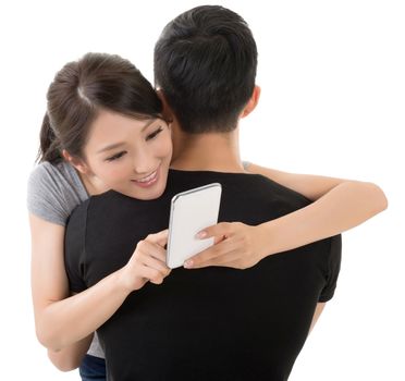 Asian woman hug her boyfriend and use the cellphone.