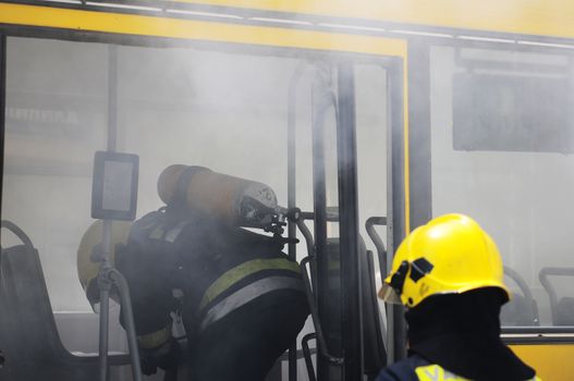 SERBIA, BELGRADE - APRIL 27, 2012: Fire fighters tries to extinguish burning bus on the street