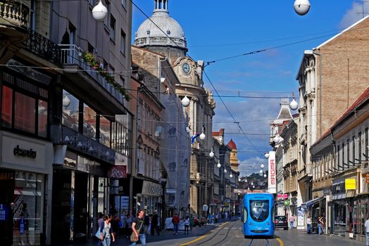 CROATIA, ZAGREB - AUGUST 9:  People travel along city street with old houses by tram in Zagreb, Croatia on August 21, 2011. Zagreb Tram run by the Zagrebacki elektricni tramvaj (ZET)