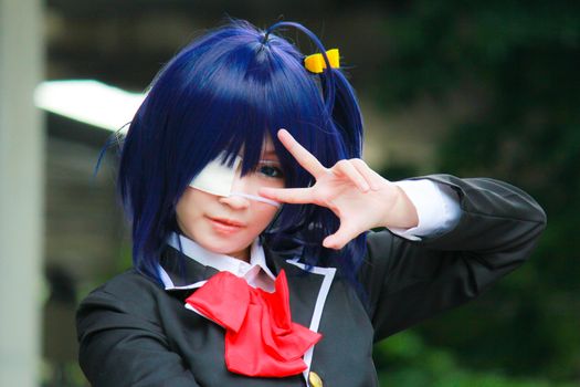 Bangkok - Aug 31: An unidentified Japanese anime cosplay Takanashi Rikka pose  on August 31, 2014 at Central World, Bangkok, Thailand.