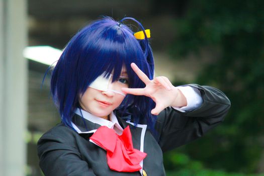 Bangkok - Aug 31: An unidentified Japanese anime cosplay Takanashi Rikka pose  on August 31, 2014 at Central World, Bangkok, Thailand.