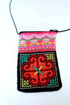 The embroidery fabric bag is the handmade from hill tribe.There are artworks that can found common in northern of Thailand.