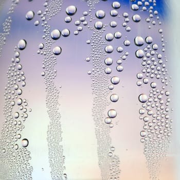 Abstract background. Drops of water on the crooked glass, shallow dof