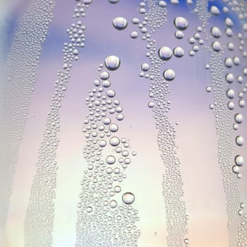 Abstract background. Drops of water on the crooked glass, shallow dof