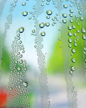 Abstract background. Drops of water on the crooked glass, shallow dof