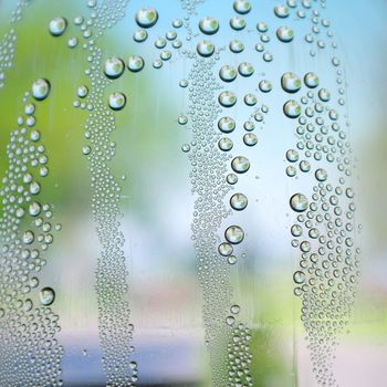 Abstract background. Drops of water on the crooked glass, shallow dof