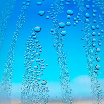 Abstract background. Drops of water on the crooked glass, shallow dof
