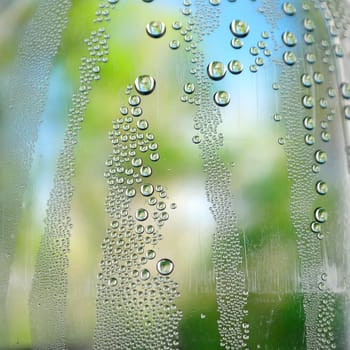 Abstract background. Drops of water on the crooked glass, shallow dof