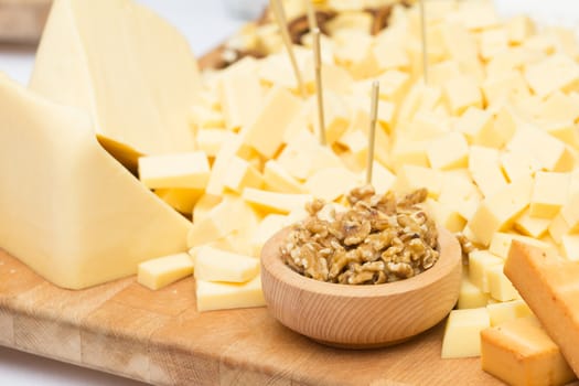 Cheese Plate with Dried Fruit, Nuts and Honey. Rustic decoration on a wooden plate.