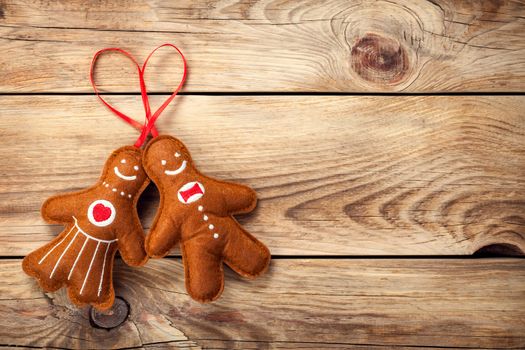 Gingerbread man and woman on wooden table background. Christmas composition with copy space. Top view