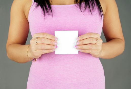 Woman in pink holding blank paper ready for text
