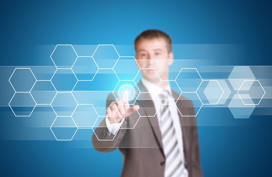 Businessman in suit finger presses virtual button. Transparent hexagons and glow circles as backdrop