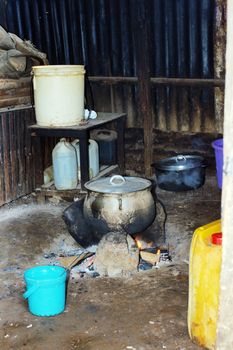 Wood burning cooking in tin shed in urban Africa