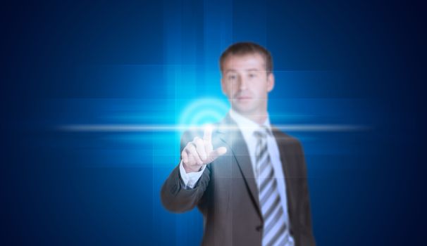 Businessman in suit finger presses virtual button. Blue background