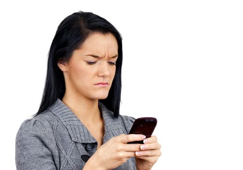 Young woman with cell phone unhappy with selfie or text