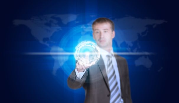 Businessman in suit finger presses virtual button. World map as backdrop