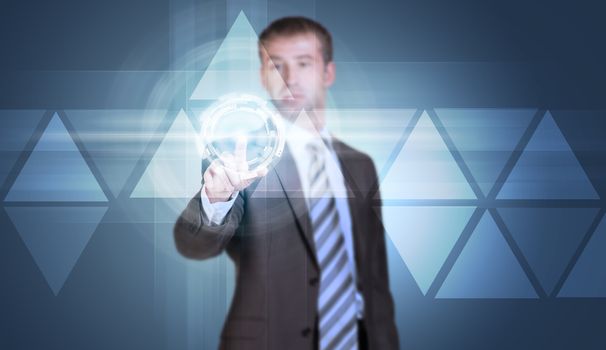 Businessman in suit finger presses virtual button. Blue background