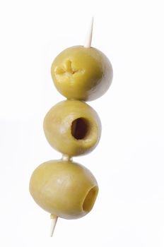three pitted green olives on wooden stick