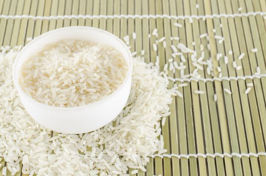 uncook rice in mini bowl on wooden pad