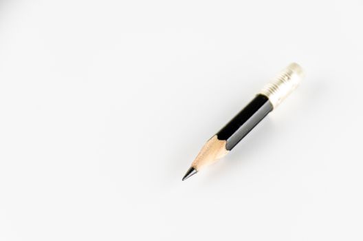 short black pencil on a white background