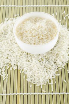 uncook rice in mini bowl on wooden pad