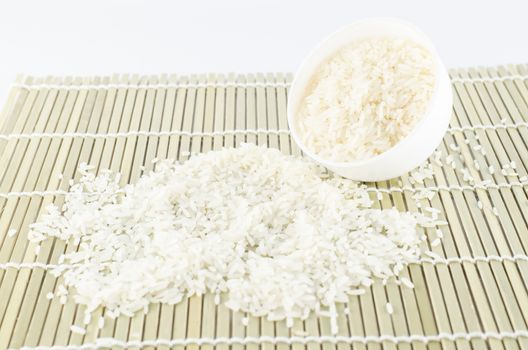 uncook rice in mini bowl on wooden pad