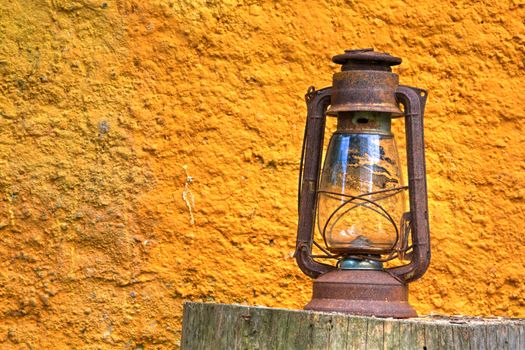 Photo shows rural lamp with yellow background.