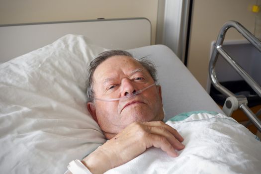 Portrait of sick old man in hospital bed