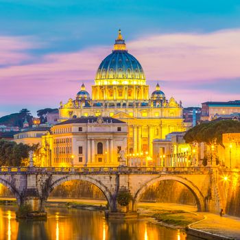 Night view of old roman Bridge of Hadrian and St. Peter's cathedral in Vatican City Rome Italy.