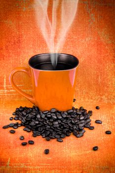 Grungy orange mug filled with hot black roast coffee with beans