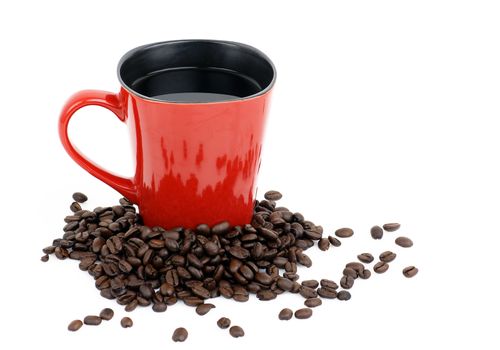 Red coffee mug with whole dark roast beans around it