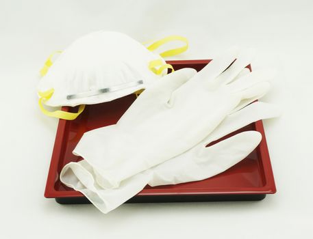 Filter masks and gloves for protection against dirt and germs placed on the tray.                               