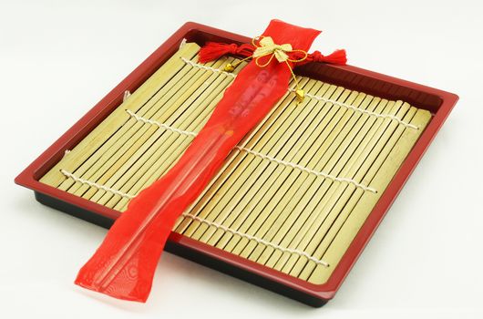 Chopsticks was contained in red container, tied with red cord and the exterior has a gold bow attached.                            