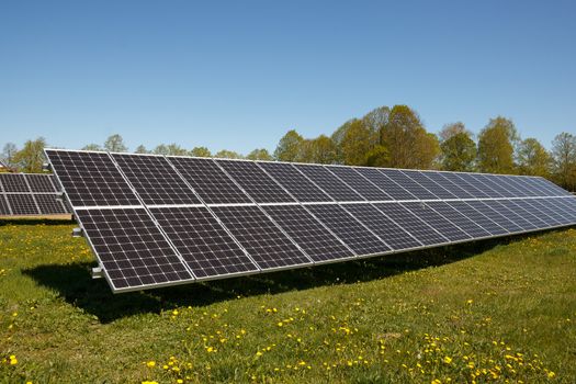 A set of solar panels on a field of grass