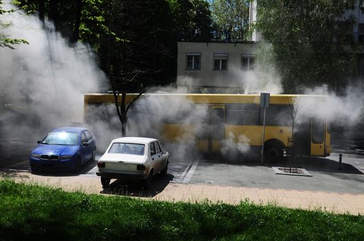 SERBIA, BELGRADE - APRIL 27, 2012: Bus on fire on the street in the middle of the day. More than have of the busses in Belgrade are older than 10 years